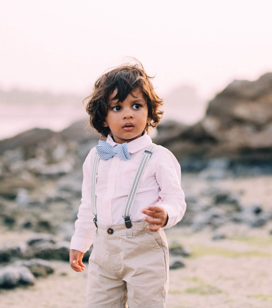 Portraits in Dubai: Gorgeous Indian boy standing in the beach