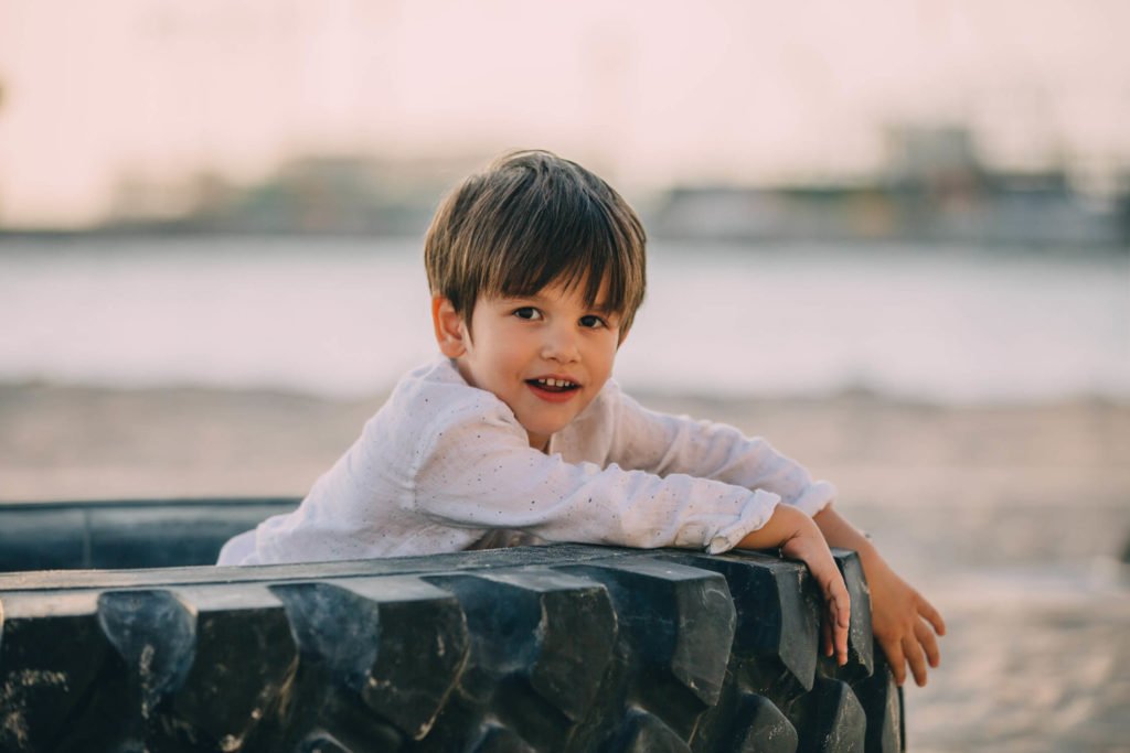 A boy plays inside a truck tyre in Abu Dhabi