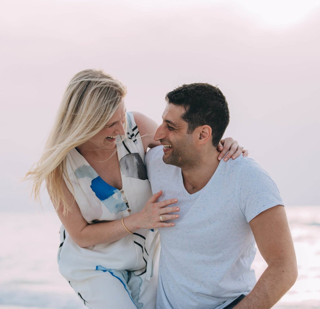 Dubai best photographer: A young couple laughs in the beach in Abu Dhabi