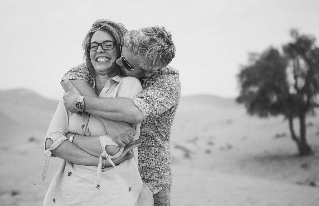 Photographer in Dubai: A man holds his wife from the back