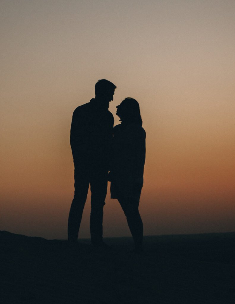 Silhouette of a couple during sunset in Dubai desert