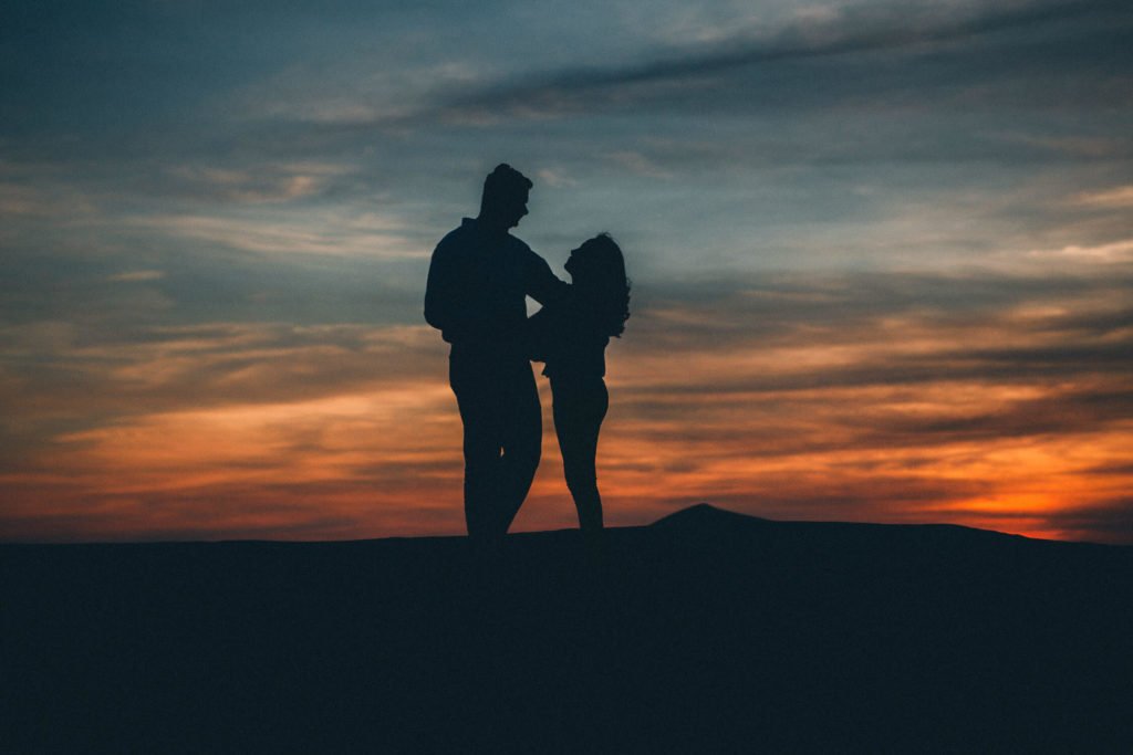 Siloutte of a couple during a beautiful desert sunset in Dubai and Abu Dhabi