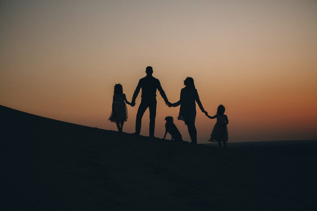 Silhouette of a family at sunset. Dubai family photographer