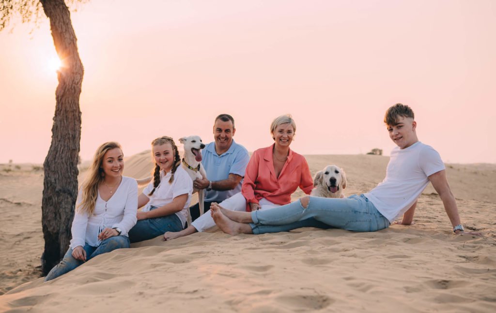 A family party of five with two dogs. Mum, dad and teenagers