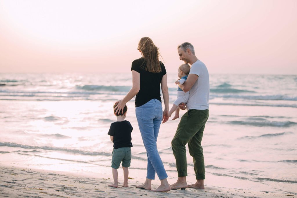 Family having a walk during sunset at the beach in Dubai. Family photographer Dubai Abu Dhabi