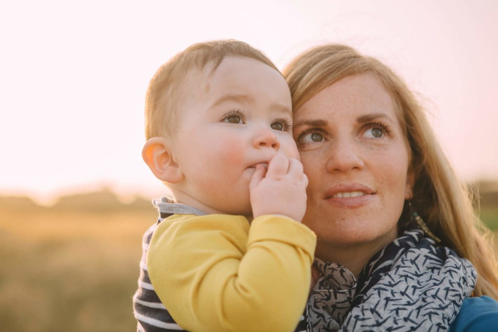 A mother and her baby boy looking towards the sky during sunrise in Dubai and Abu Dhabi