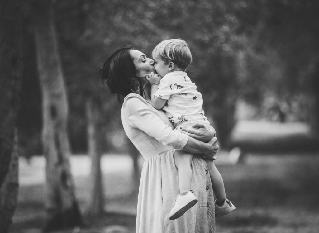 A mum and her toddler hug in a park in Abu Dhabi and Dubai. Family photography