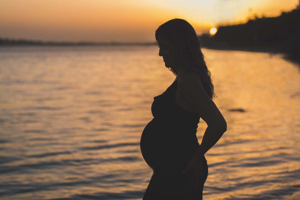 Beautiful maternity session: Silhouette of a pregnant lady during Abu Dhabi sunset