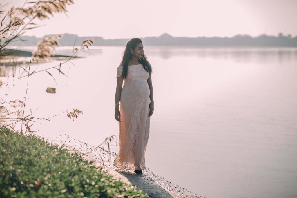 Pregnant woman walking in the beach at sunrise in Abu Dhabi.