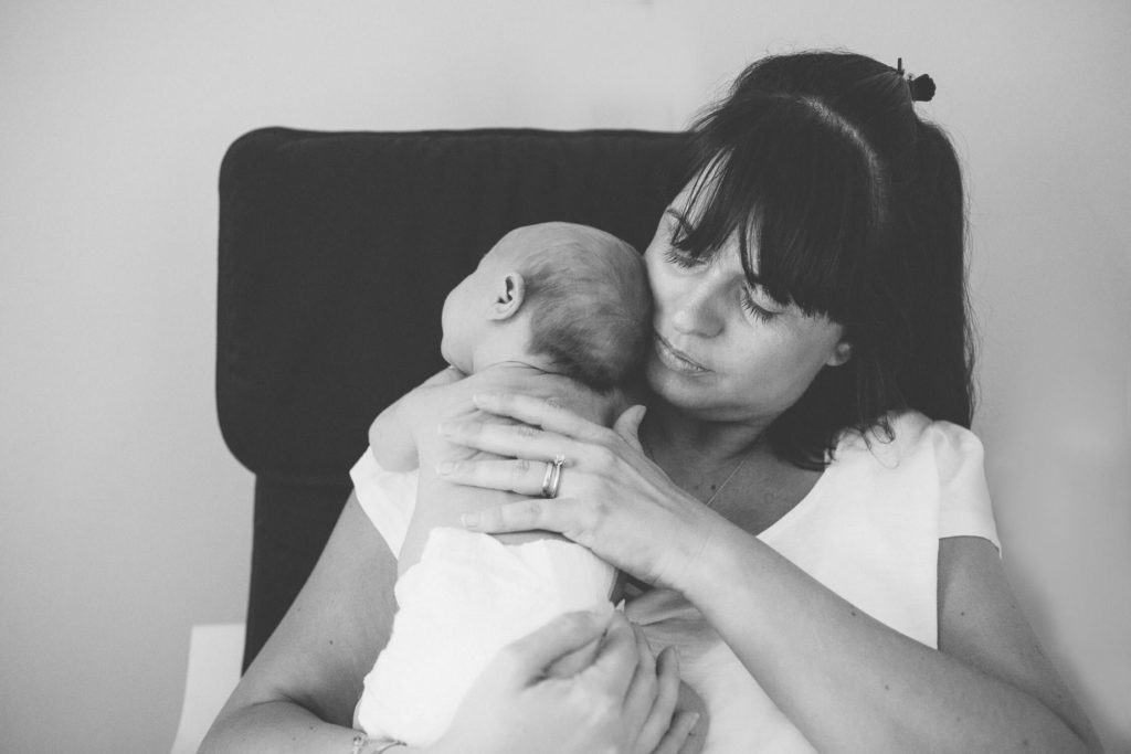 Mum carrying her newborn baby