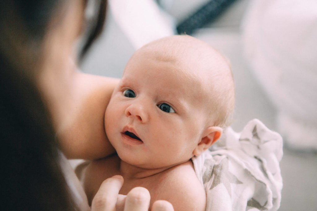 Newborn baby in Dubai looks at her mum
