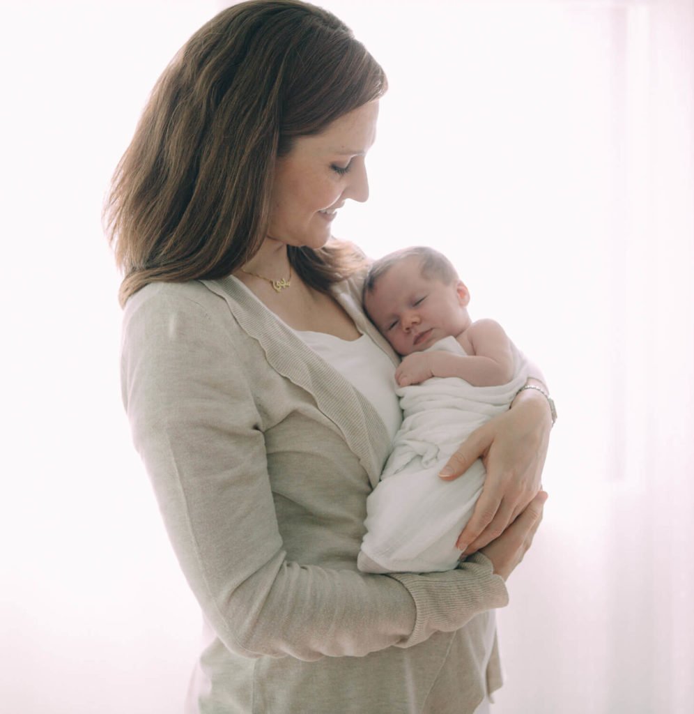 Mum carries her newborn