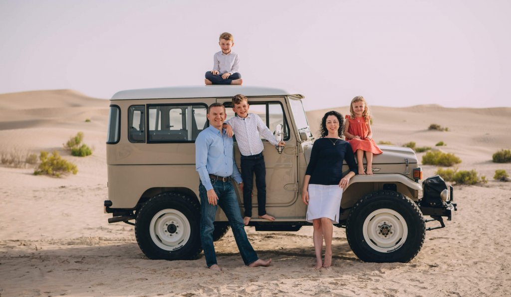 Farewell to the Dubai and Abu Dhabi desert. Family in an old fashioned jeep in the dunes