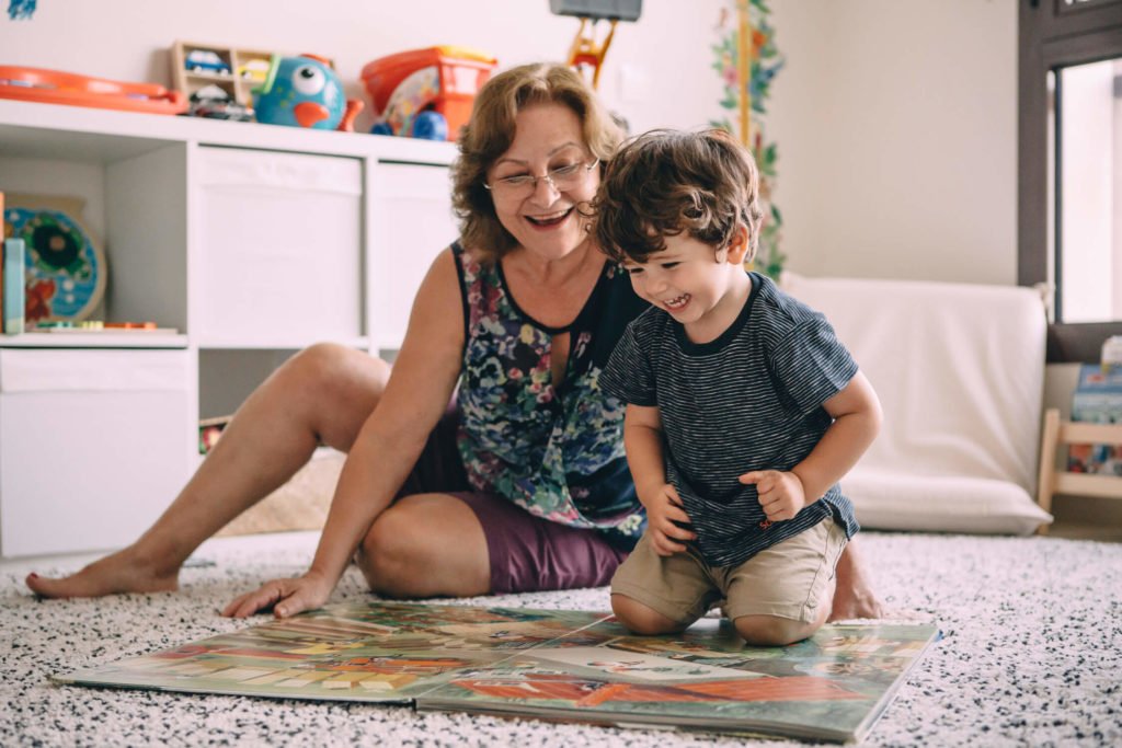 In-home lifestyle family session. Grandmother and toddler laugh together