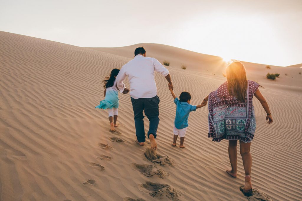 Family and desert photo session in Abu Dhabi. Family walking in the Abu Dhabi sand dunes