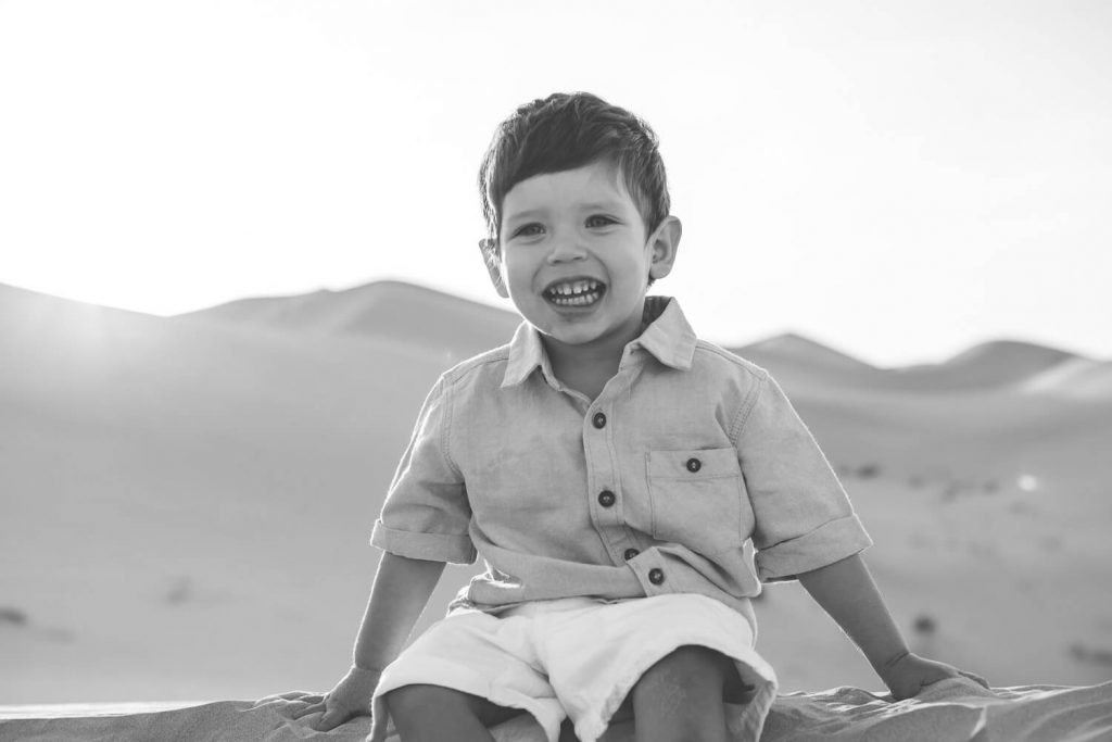 Children and desert photographer in Abu Dhabi. Portrait of a boy in the desert