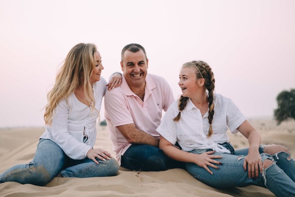 A father and his teenagers in the desert of Dubai and Abu Dhabi 
